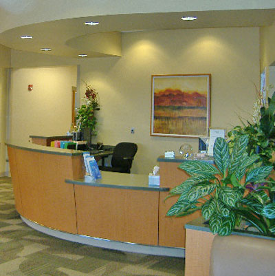 Interior image of the reception area at Memorial Hermann Cy-Fair Plaza with plans at the desk.