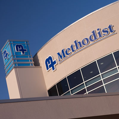Exterior view of Methodist North at Allen Road sign and logo on the side of the building.