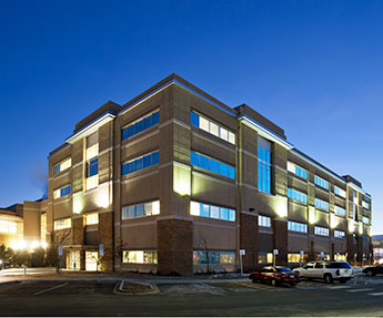 Photo of the exterior view of the Parker Professional Building at night time.
